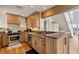Bright kitchen features stainless steel appliances, light wood cabinetry, and views of the living area and water at 6847 S Atlantic Ave, New Smyrna Beach, FL 32169
