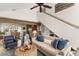 Bright living room with high ceilings, ceiling fan, comfortable seating, and stairs leading upstairs at 6847 S Atlantic Ave, New Smyrna Beach, FL 32169
