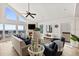 Bright living room with ocean views, comfortable sofa, and a cozy fireplace at 6847 S Atlantic Ave, New Smyrna Beach, FL 32169
