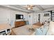 Open concept living area features a mounted tv, modern furniture, and a comfortable seating area at 6847 S Atlantic Ave, New Smyrna Beach, FL 32169