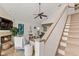 Bright living area featuring a fireplace, comfortable seating, and a staircase leading to the second floor at 6847 S Atlantic Ave, New Smyrna Beach, FL 32169