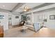 Open concept living area features a spiral staircase, a comfortable seating area and lots of natural light at 6847 S Atlantic Ave, New Smyrna Beach, FL 32169