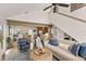 Comfortable living room with high ceilings, ceiling fan, comfortable seating, and view to kitchen and dining area at 6847 S Atlantic Ave, New Smyrna Beach, FL 32169