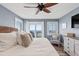 Light-filled main bedroom boasts a ceiling fan, calming colors, and a private balcony with ocean view at 6847 S Atlantic Ave, New Smyrna Beach, FL 32169