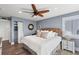 Calming bedroom with ceiling fan, linen headboard, ample storage, and soft coastal colors create a serene retreat at 6847 S Atlantic Ave, New Smyrna Beach, FL 32169