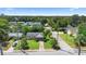 Aerial view of a charming single-story home with a covered carport and spacious front yard at 708 Wayne Ave, New Smyrna Beach, FL 32168