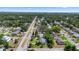 Expansive aerial view showcasing a tranquil residential neighborhood with tree-lined streets and tidy homes at 708 Wayne Ave, New Smyrna Beach, FL 32168