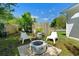 Green backyard featuring a fire pit with chairs and bamboo fencing providing additional privacy at 708 Wayne Ave, New Smyrna Beach, FL 32168