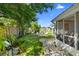 Lush backyard with a small fire pit, mature trees, bamboo fencing and a screened-in porch at 708 Wayne Ave, New Smyrna Beach, FL 32168