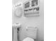 This cozy bathroom features a pedestal sink and mirrored cabinet for extra storage at 708 Wayne Ave, New Smyrna Beach, FL 32168