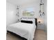 This serene bedroom offers natural light and pendant lights to help you relax at 708 Wayne Ave, New Smyrna Beach, FL 32168