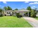 Charming single-story home with a well-maintained lawn and a covered carport at 708 Wayne Ave, New Smyrna Beach, FL 32168