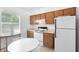 Charming kitchen features wooden cabinets, a white refrigerator, an electric stove and dining area at 708 Wayne Ave, New Smyrna Beach, FL 32168