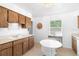 Cozy kitchen features wooden cabinets, white countertops, breakfast nook, and natural light at 708 Wayne Ave, New Smyrna Beach, FL 32168