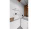 This laundry room is equipped with a washer and storage shelves for cleaning supplies at 708 Wayne Ave, New Smyrna Beach, FL 32168