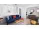 Bright living room with blue sofa, wood floors, and decorative pillars at 708 Wayne Ave, New Smyrna Beach, FL 32168
