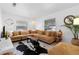 Cozy living room with a large sectional sofa, stylish rug, and ample natural light at 708 Wayne Ave, New Smyrna Beach, FL 32168