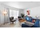 Inviting living room with comfortable blue sofa, modern decor, and bright natural light at 708 Wayne Ave, New Smyrna Beach, FL 32168