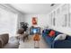 Comfortable living room with a blue sofa, side chairs, and natural light from a large window at 708 Wayne Ave, New Smyrna Beach, FL 32168