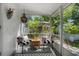 The stylish sunroom features a black and white color scheme with comfortable seating at 708 Wayne Ave, New Smyrna Beach, FL 32168