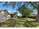 Back exterior of home featuring backyard and screened in porch at 801 Coleman Ave, Deltona, FL 32725