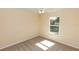Bedroom with neutral-colored walls, carpet flooring, ceiling fan, and a window for natural light at 801 Coleman Ave, Deltona, FL 32725