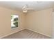 Neutral bedroom featuring carpet, a window, and a ceiling fan at 801 Coleman Ave, Deltona, FL 32725