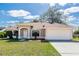 Lovely one-story home with a manicured lawn, a two-car garage, and a cozy front porch at 801 Coleman Ave, Deltona, FL 32725