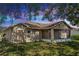 Rear exterior of the home featuring a screened lanai and lush green lawn at 801 Coleman Ave, Deltona, FL 32725