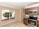 Well-lit kitchen with stainless steel appliances, tile flooring, and a large window at 801 Coleman Ave, Deltona, FL 32725