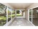 Enclosed patio with tile flooring and sliding glass doors to the backyard, perfect for entertaining at 801 Coleman Ave, Deltona, FL 32725