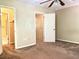 Spacious bedroom featuring carpet floors, ceiling fan, and a closet and bathroom entryway at 805 N Clake St, Deland, FL 32724