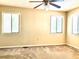 Bright bedroom featuring neutral walls, carpet flooring, and two windows with blinds at 805 N Clake St, Deland, FL 32724