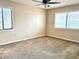 This bedroom offers natural light from the windows and a ceiling fan for added comfort at 805 N Clake St, Deland, FL 32724