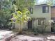 Charming townhome featuring an attached garage and a lovely palm tree in the front yard at 805 N Clake St, Deland, FL 32724