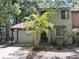 Charming townhome featuring an attached garage and a lovely palm tree in the front yard at 805 N Clake St, Deland, FL 32724
