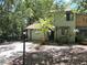 Charming townhome featuring an attached garage and a lovely palm tree in the front yard at 805 N Clake St, Deland, FL 32724