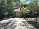 Charming townhome featuring an attached garage and a lovely palm tree in the front yard at 805 N Clake St, Deland, FL 32724