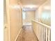 Well-lit hallway with carpet and white railings, leading to other rooms in the home at 805 N Clake St, Deland, FL 32724