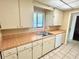 The kitchen features a stainless steel sink, white cabinets, and countertops at 805 N Clake St, Deland, FL 32724