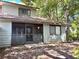 The rear exterior features a screened in porch and neutral colored siding at 805 N Clake St, Deland, FL 32724