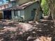 The home has a small rear yard with mature shade trees and side driveway at 805 N Clake St, Deland, FL 32724