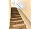 Carpeted stairs lead to the upper level of this home at 805 N Clake St, Deland, FL 32724