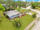 Charming home boasts lush landscaping, palm trees, and a well-manicured lawn at 88 Valencia Dr, Ormond Beach, FL 32176