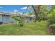 View of the spacious backyard with lush green lawn and mature trees, perfect for outdoor entertaining at 88 Valencia Dr, Ormond Beach, FL 32176