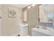 Modern bathroom with dual sinks and decorative mosaic tile backsplash and a 'Beach House' sign at 88 Valencia Dr, Ormond Beach, FL 32176