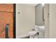 Half-bathroom featuring a tiled accent wall, modern fixtures, and sliding door at 88 Valencia Dr, Ormond Beach, FL 32176