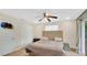 Cozy bedroom with wood-look flooring, a ceiling fan, and a large closet for ample storage at 88 Valencia Dr, Ormond Beach, FL 32176