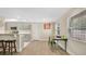 The kitchen flows into the dining area with a table near a bright window at 88 Valencia Dr, Ormond Beach, FL 32176