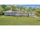 Charming single-story home with a well-maintained lawn and beautiful palm trees at 88 Valencia Dr, Ormond Beach, FL 32176
